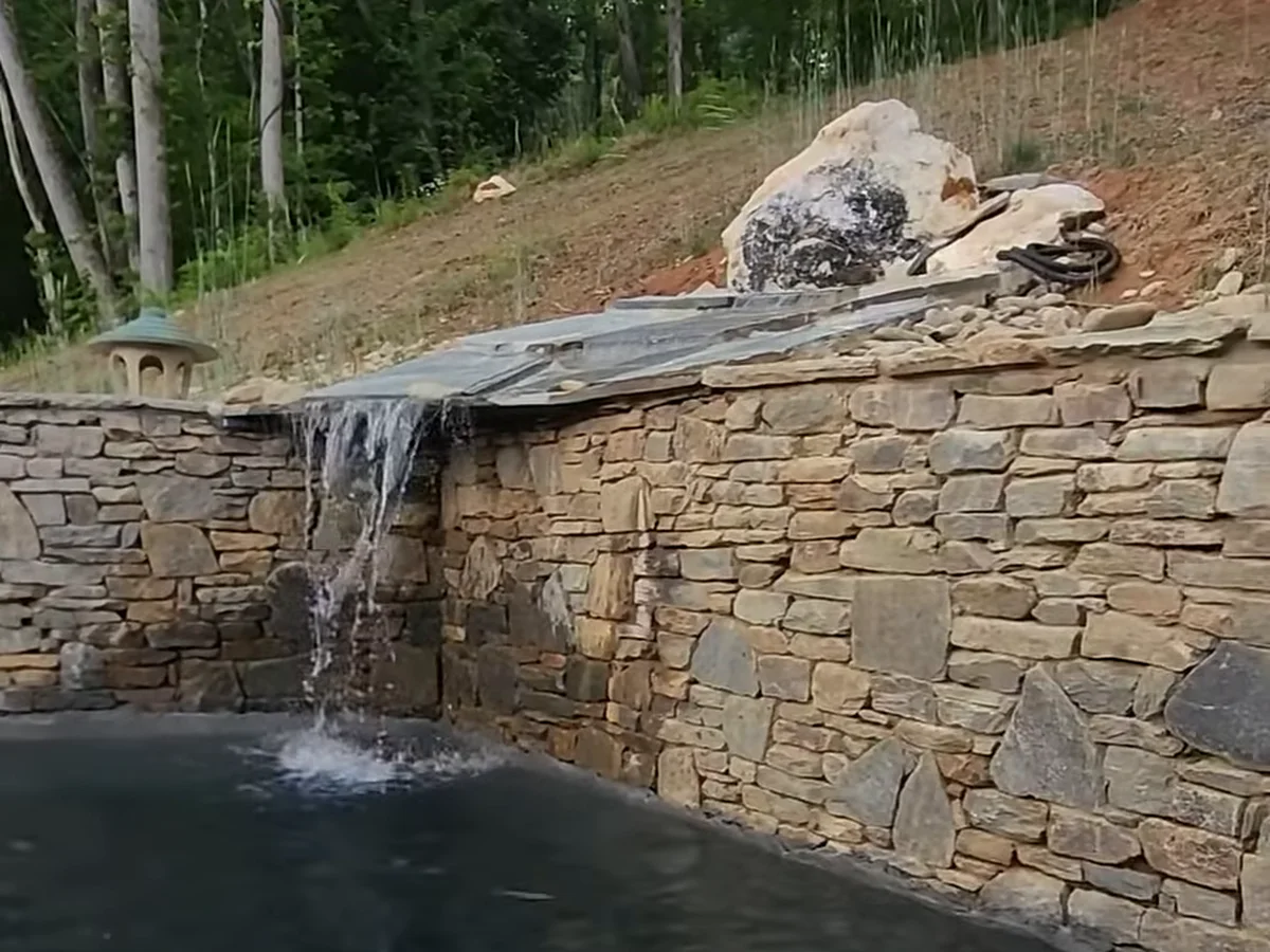 A stone waterfall we built, spilling into a pond